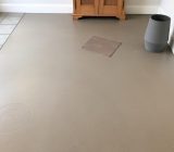 Waxed concrete effect floor with tile glue: why is it not a good idea?
